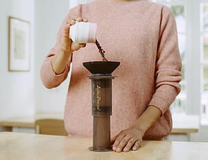 The Aeropress being filled with ground coffee