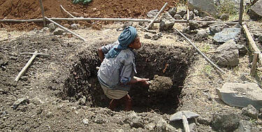 A worker digs foundations