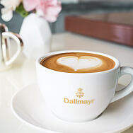 Dallmayr cappuccino csészében latte-art szívvel díszítve