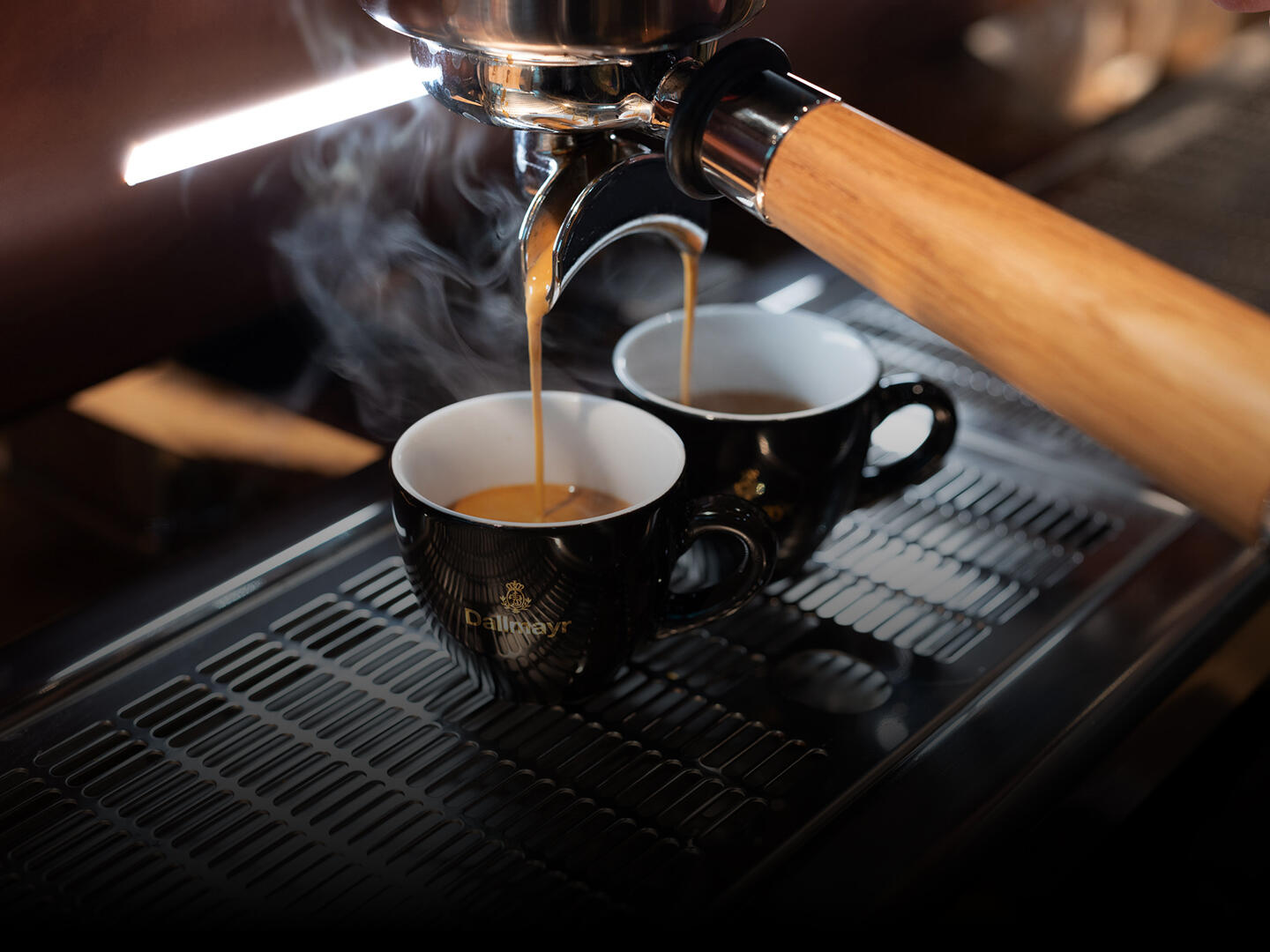 Dallmayr espresso runs from the portafilter machine into two espresso cups