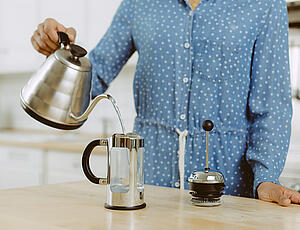 A French press being preheated with hot water