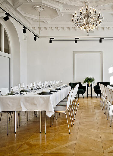 Event Location mit weiß gedeckten Tischen in einem Saal